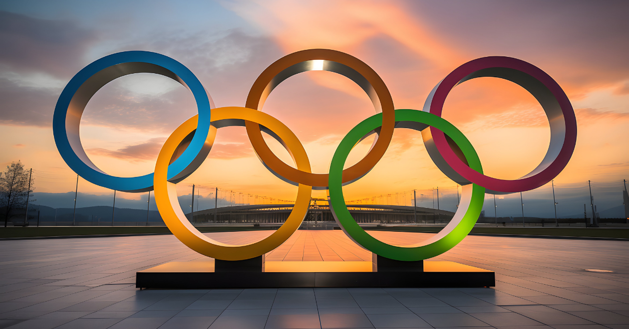 Símbolo das Olimpíadas: cinco grandes argolas entrelaçadas nas cores azul, amarela, preta, verde e vermelha, representando a união dos continentes e o espírito olímpico.